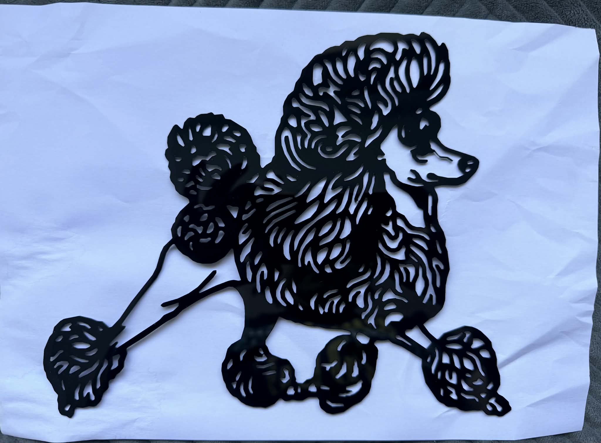 Black acrylic laser-cut piece of a poodle in a show stack pose